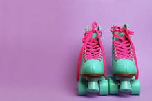 Turquoise roller skates with bright pink laces